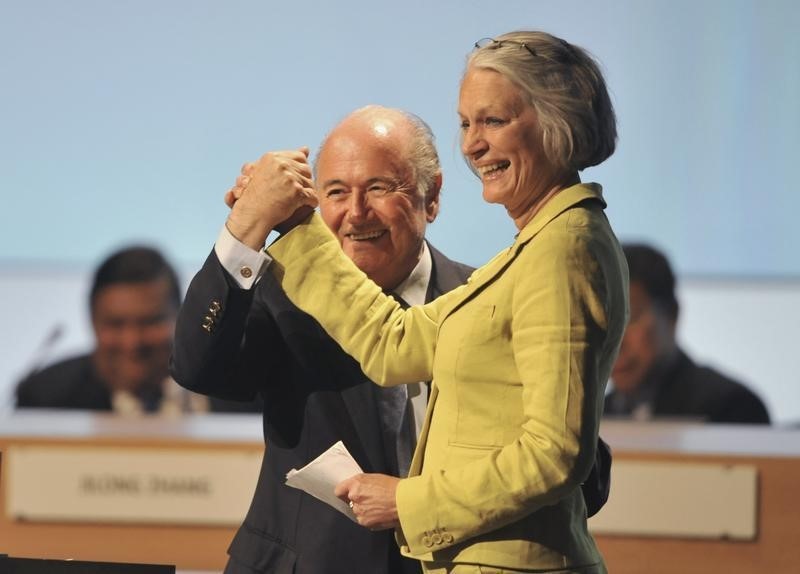 © Reuters. FIFA President Blatter holds the hand of Bente Erichsen, director of the Nobel Peace Center, during the 62nd FIFA Congress in Budapest