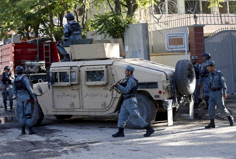 © Reuters. Afghan policemen stand guard near the site of an attack in Kabul