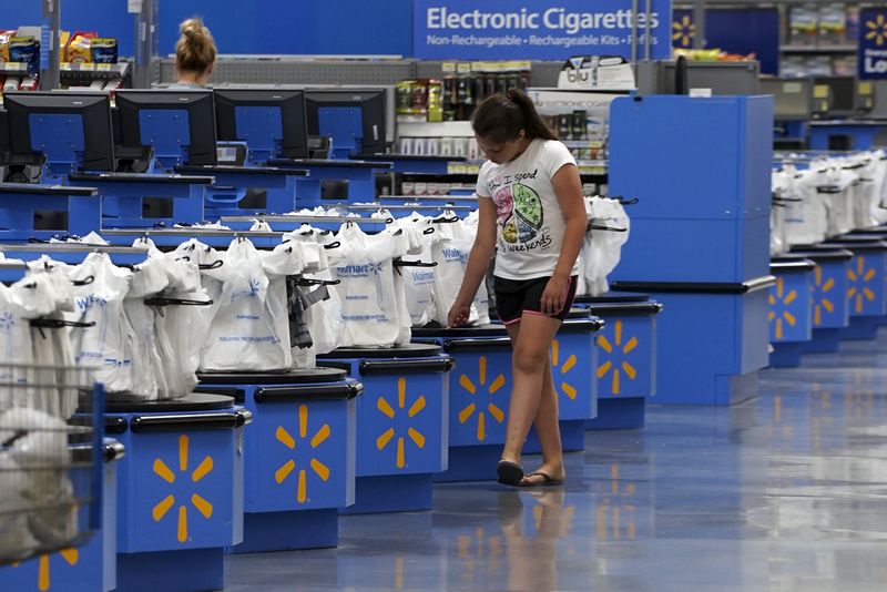 © Reuters. A girl walks along the checkouts at the Wal-Mart Supercenter in Springdale

