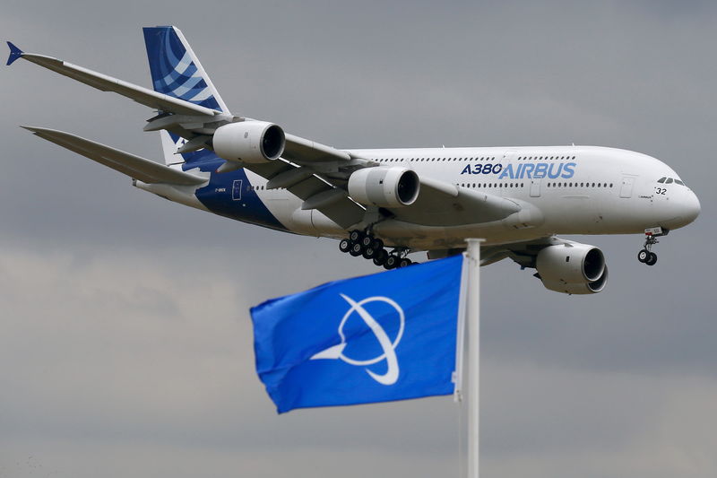 © Reuters. An Airbus A380, the world's largest jetliner, flies over a Boeing flag while landing after a flying display during the 51st Paris Air Show at Le Bourget airport near Paris