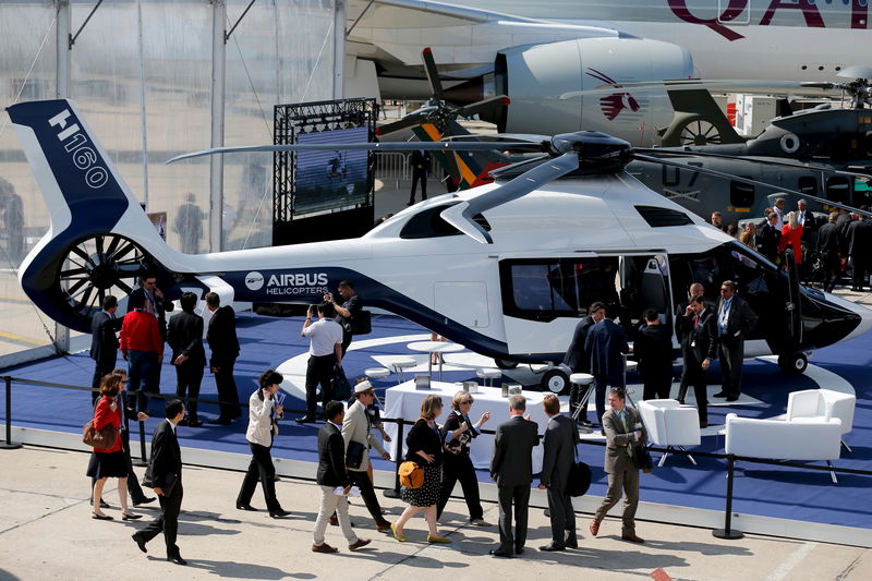 © Reuters. Visitors look at A H160 of Airbus Helicopter on display during the 51st Paris Air Show at Le Bourget airport near Paris