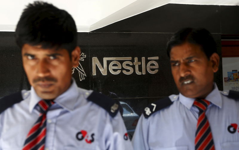 © Reuters. Security guards stand guard outside a corporate office of Nestle in New Delhi