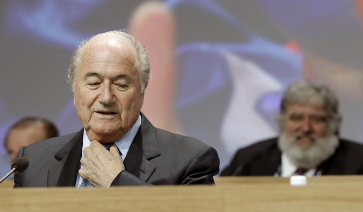 © Reuters. A file picture shows FIFA President Blatter standing in front of executive member Blazer of the U.S. during the 61st FIFA congress in Zurich