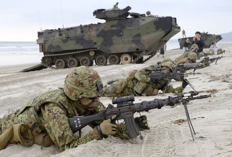 © Reuters. File photo of Japanese Ground Self-Defense Force's soldiers taking positions after landing on the beach near U.S. Marine Corps AAV7 armored personnel vehicles during a joint landing exercise at Marine Corps Base Camp Pendleton in California
