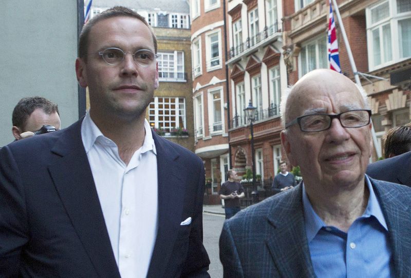 © Reuters. File photograph shows News International Chairman, James Murdoch and his father Rupert, leaving the Stafford Hotel in central London
