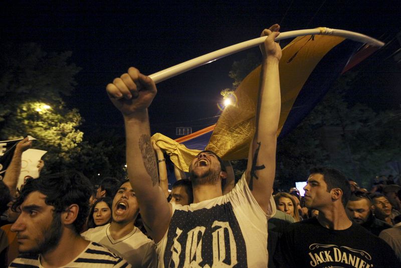 © Reuters. Protesters shout slogans during rally against recent decision to raise public electricity prices in Yerevan