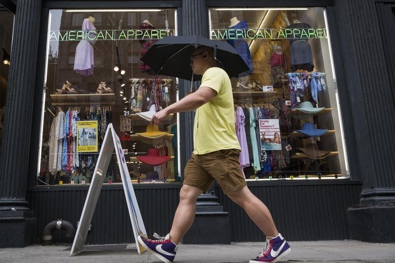 © Reuters. A man walks past an American Apparel store in New York