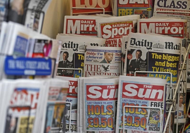 © Reuters. British newspapers are displayed at a newsagent's stand in central London