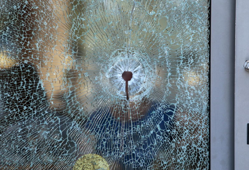 © Reuters. A broken glass window of the Imperiale Marhaba hotel is seen after a gunman opened fire at the beachside hotel in Sousse, Tunisia