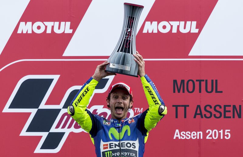 © Reuters. Yamaha MotoGP rider Valentino Rossi of Italy celebrates on the podium after winning the MotoGP race at the TT Assen Grand Prix at Assen, the Netherlands