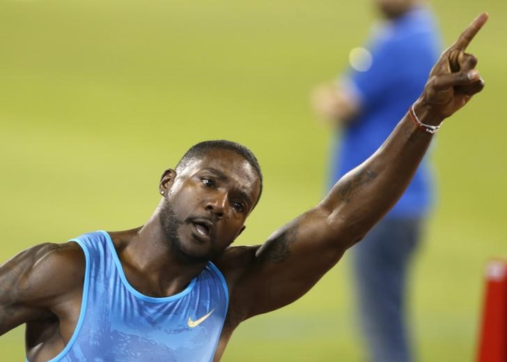 © Reuters. Gatlin from the US reacts after winning the men's 100 meters event during the Diamond League meeting in Doha