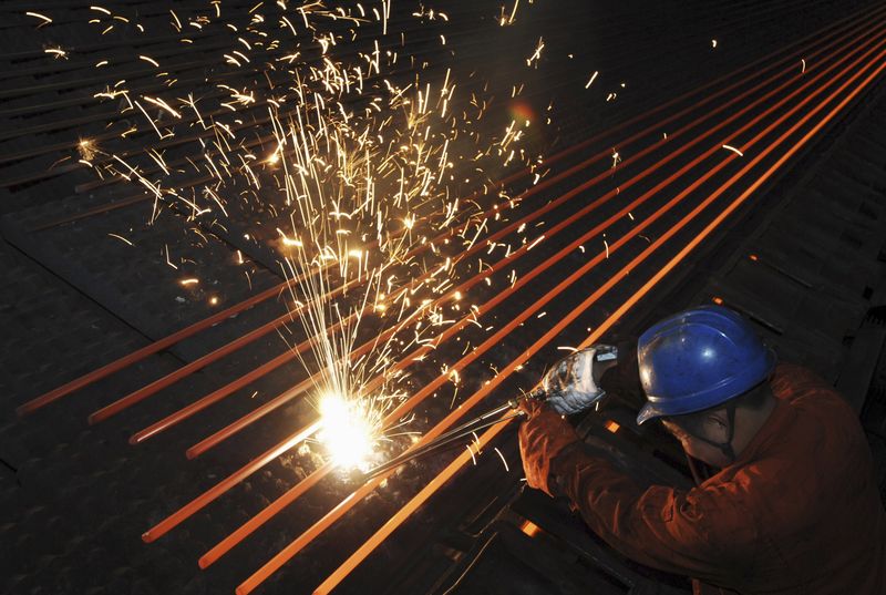 © Reuters. File photo of an employee working at a steel factory in Dalian