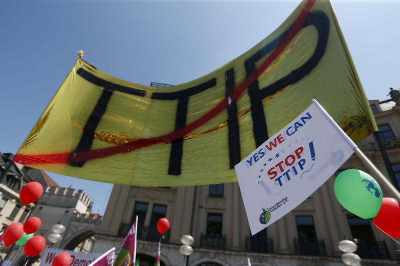 © Reuters. File photo of people demonstrating against TTIP during protest rally prior to the G7 summit in Munich