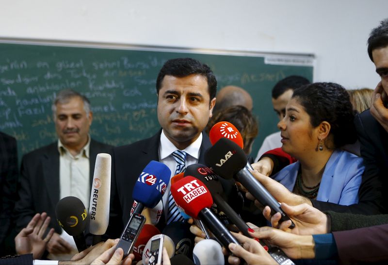 © Reuters. Demirtas, co-chairman of the pro-Kurdish Peoples' Democratic Party (HDP), talks to the media before casting his ballot at a polling station