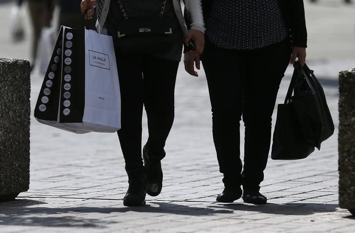 © Reuters. Women walk with shopping bags in Strasbourg during the start of summer sales in France