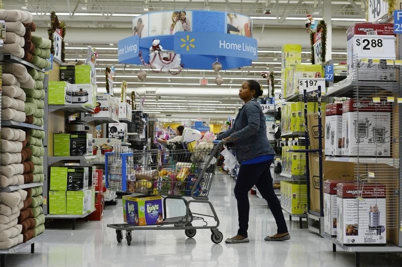 © Reuters. A customer pushes her shopping cart through the aisles at a Walmart store in the Porter Ranch section of Los Angeles