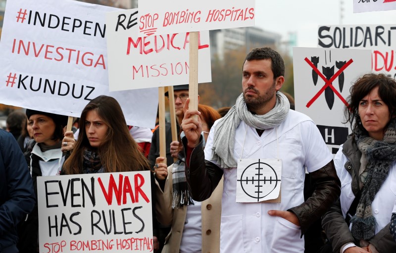 © Reuters. Staff of MSF demonstrates one month after the US bombing of their charity-run hospital in Kunduz in Afghanistan in Geneva