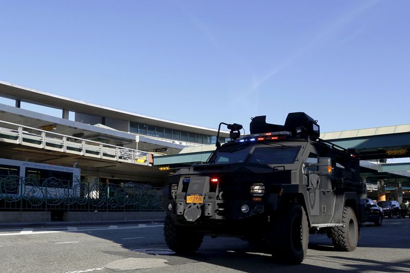 © Reuters. A Port Authority Police armored vehicle drives through the passenger pick-up area at La Guardia Airport in New York 