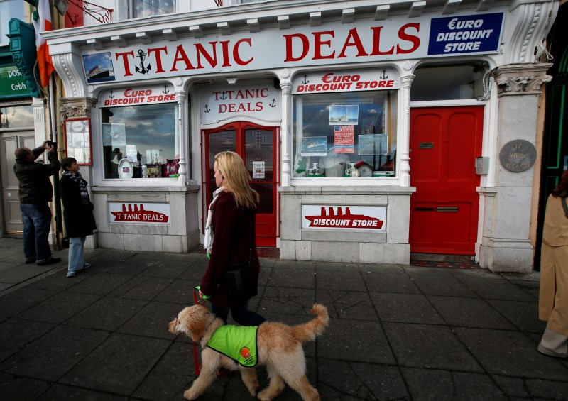 © Reuters. A woman passes the Titanic discount shop in Cobh