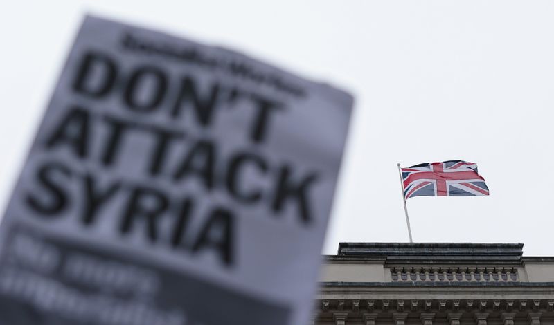 © Reuters. A British flag flies from a building on Whitehall during a rally against taking military action against Islamic State in Syria, held outside Downing Street in London