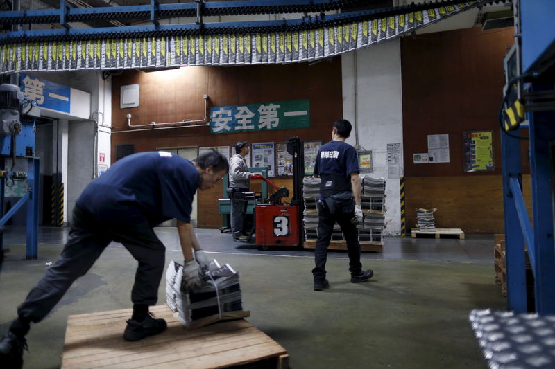 © Reuters. An employee operates a forklift to transport a pallet stacked with bundles of the Apple Daily newspaper, published by Next Media, at the company's printing facility in Hong Kong, China 
