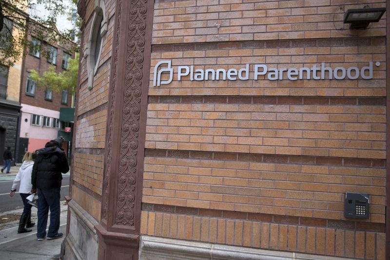 © Reuters. People walk past a Planned Parenthood clinic in the Manhattan borough of New York