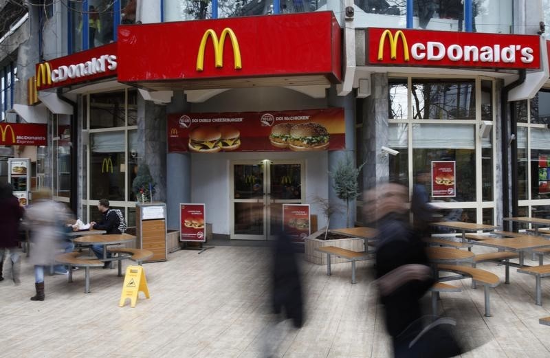 © Reuters. People walk in front of a McDonald's restaurant in Buchares