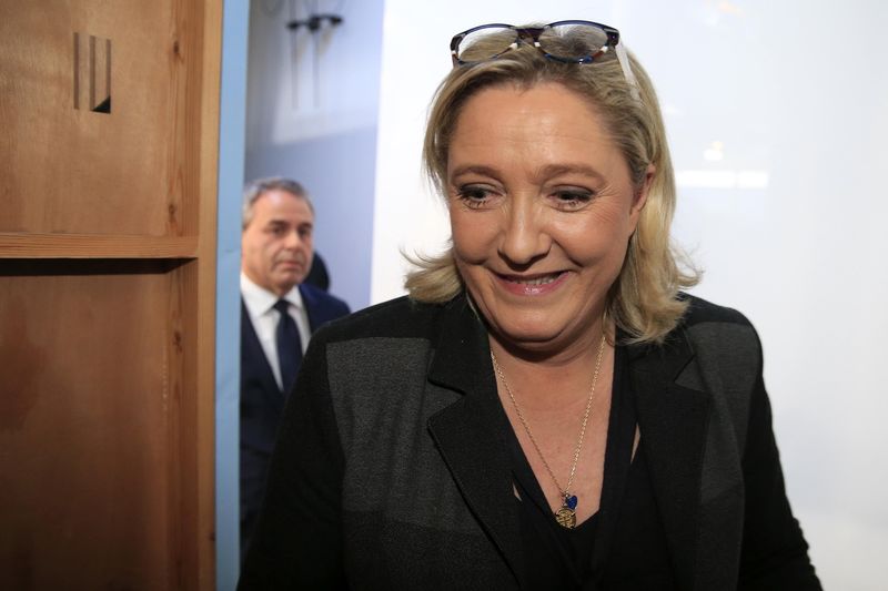 © Reuters. French National Front leader and candidate Marine Le Pen and Xavier Bertrand, candidate for Les Republicains, leaves after a broadcast debate in Lille