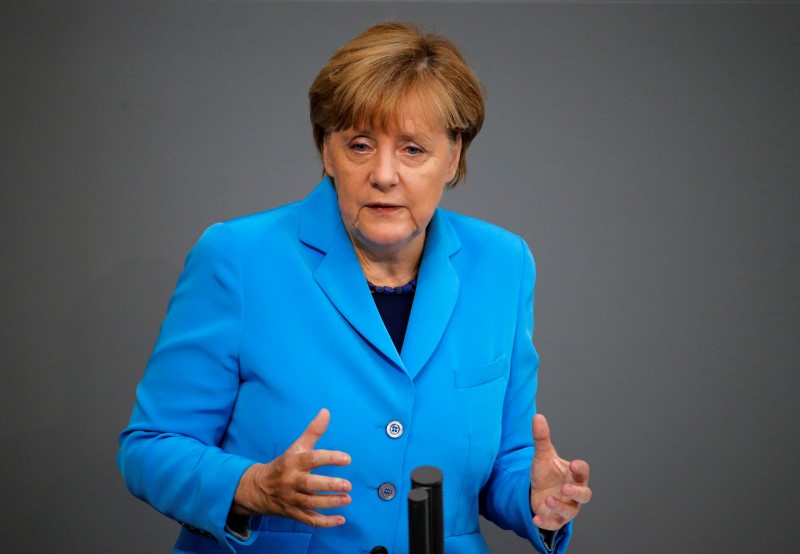 © Reuters. German Chancellor Merkel gestures as she addresses the lower house of parliament Bundestag on Germany's 2016 budget in Berlin