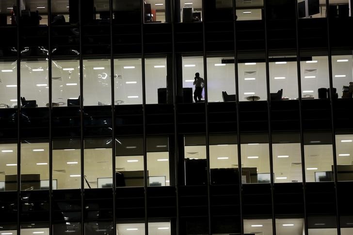 © Reuters. A man speaks on the telephone in an office  in the financial district of Canary Wharf