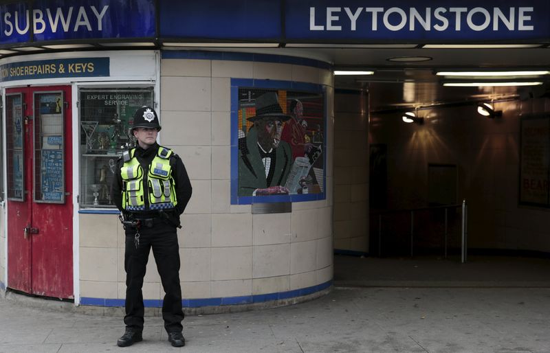 © Reuters. A police officer patrols outside Leytonstone Underground station in east London