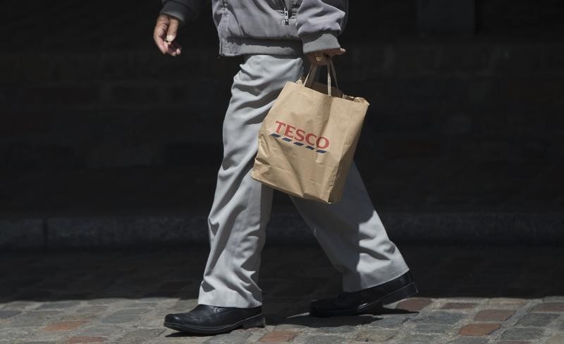 © Reuters. A Tesco shareholder leaves after attending the company's annual general meeting in London