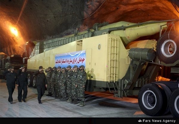 © Reuters. Members of Iran's Islamic Revolutionary Guard Corps (IRGC) Aerospace Force salute at an underground missile base with launcher units in an undisclosed location in this undated handout photo courtesy of Fars News