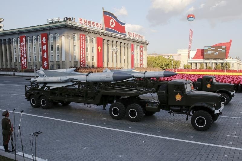 © Reuters. Missiles are taken on trucks past a stand with North Korean leader Kim Jong Un during the parade celebrating the 70th anniversary of the founding of the ruling Workers' Party of Korea, in Pyongyang