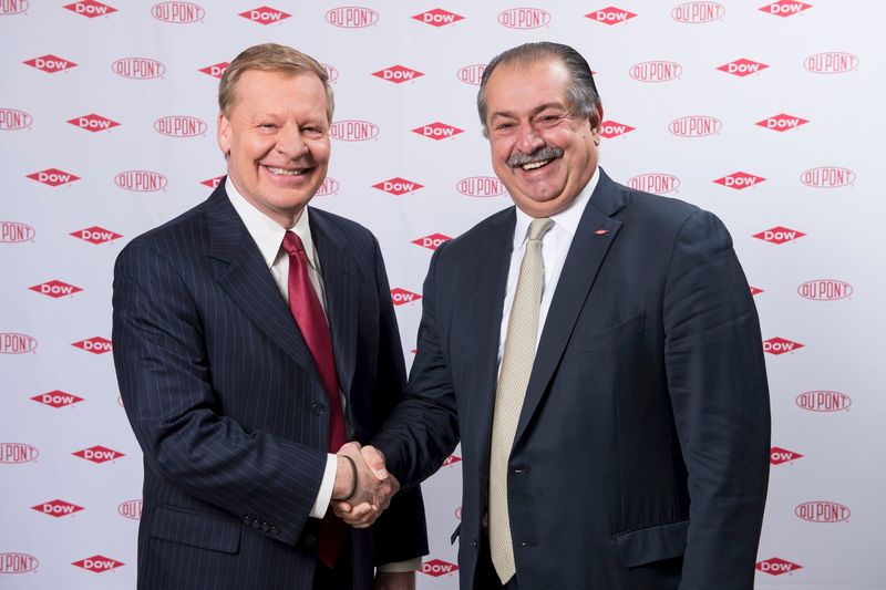 © Reuters. Breen, chairman and chief executive officer of DuPont, is pictured shaking hands with Liveris, Dowâ€™s chairman and chief executive officer, in this undated handout photo provided by DuPont