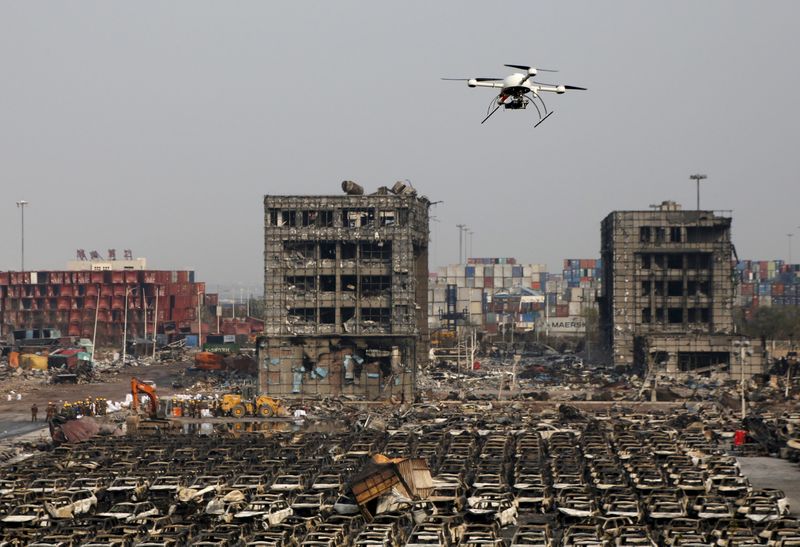 © Reuters. File photo of a drone operated by paramilitary police flying over the site of August 12, 2015 explosions at Binhai new district in Tianjin, China