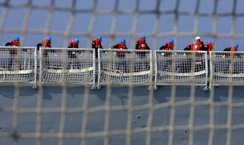 © Reuters. File photo of crew members tugging a rope as they participate in a navy exercise in Kaohsiung