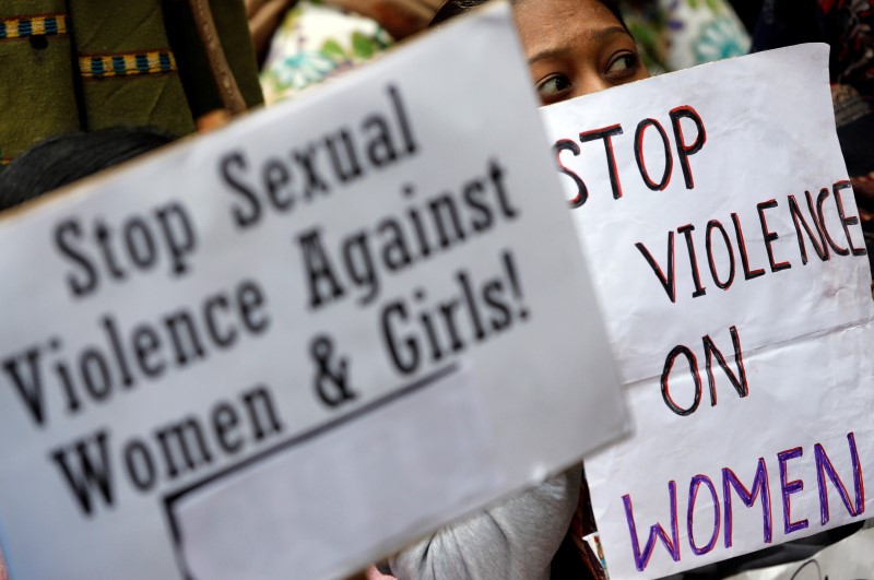 © Reuters. Demonstrator holds placards during a protest in New Delhi