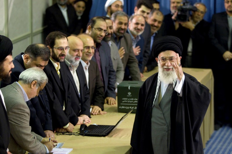 © Reuters. Iran's Supreme Leader Ayatollah Khamenei waves to the media after presenting his identification papers to cast his ballot in the parliamentary election in Tehran