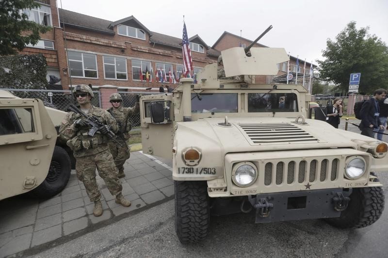 © Reuters. U.S. soldiers stand near a Humvee vehicle during the NATO Force Integration Unit inauguration event in Vilnius