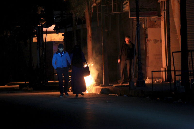 © Reuters. Residents walk along a street at night in Idlib, Syria