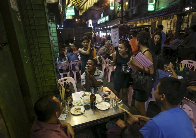 © Reuters. People drink beer in 19th street, also known as Yangon beer street, in Yangon