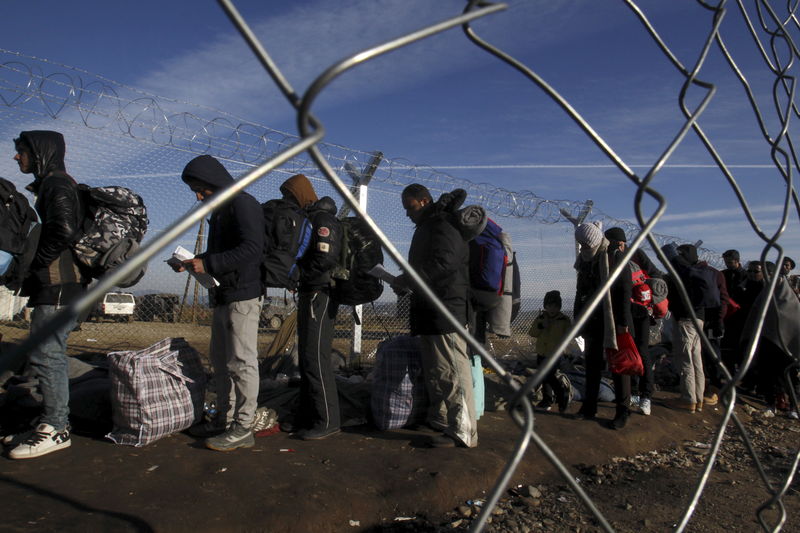 © Reuters. Refugees line up as they wait to cross the Greek-Macedonian border, near the village of Idomeni, Greece