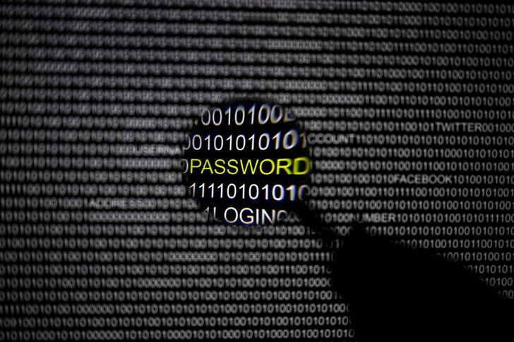 © Reuters. A magnifying glass is held in front of a computer screen in this picture illustration taken in Berlin