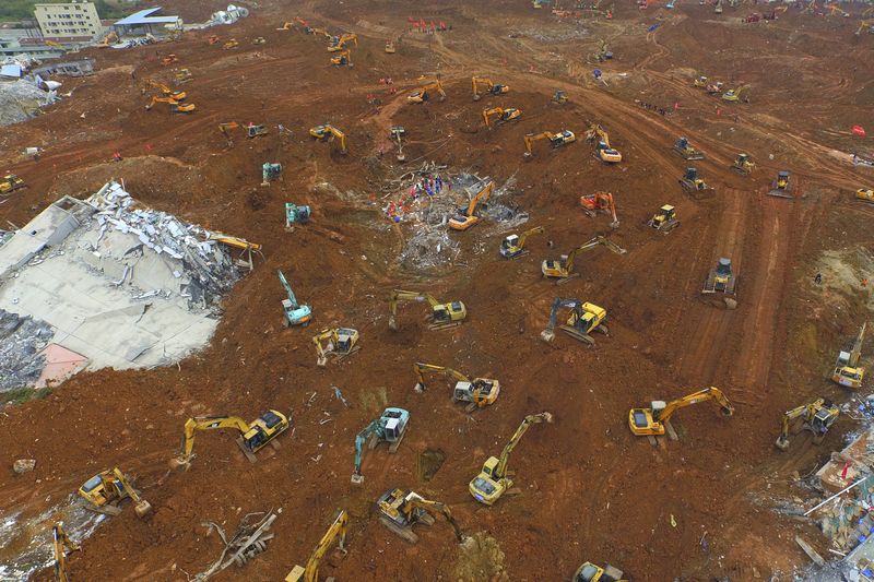 © Reuters. An aerial view shows excavators and rescuers work among the debris at the site of a landslide which hit an industrial park on Sunday, in Shenzhen