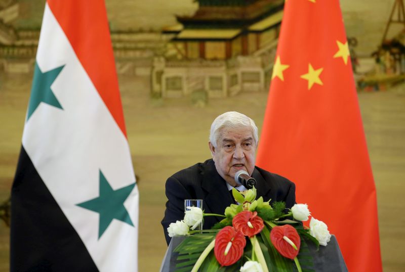 © Reuters. Syria's Foreign Minister Moualem speaks during a joint news conference with China's Foreign Minister Wang after a meeting at the Ministry of Foreign Affairs in Beijing