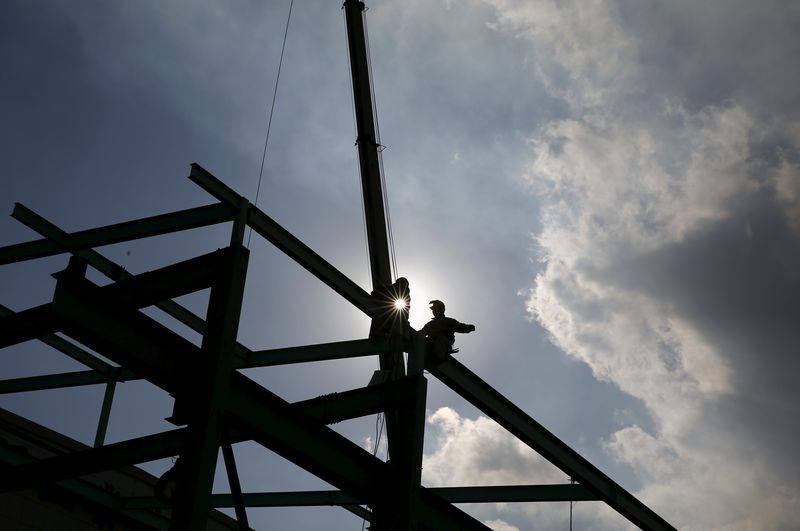 © Reuters. Men work on constructing a metal structure at a factory at the Keihin industrial zone in Kawasaki, south of Tokyo