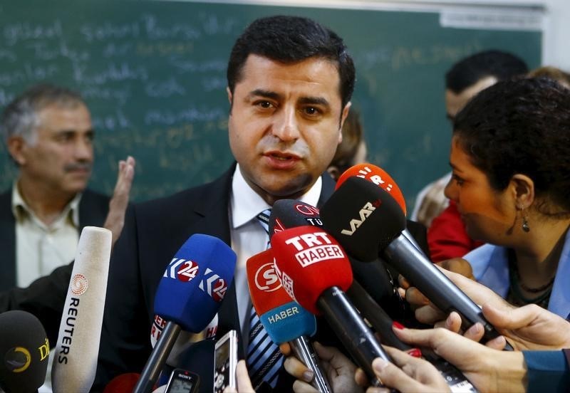 © Reuters. Demirtas, co-chairman of the pro-Kurdish Peoples' Democratic Party (HDP), talks to the media before casting his ballot at a polling station