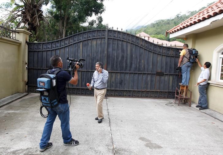 © Reuters. Journalists stand outside the main access to a property of the Rosenthal family in San Pedro Sula