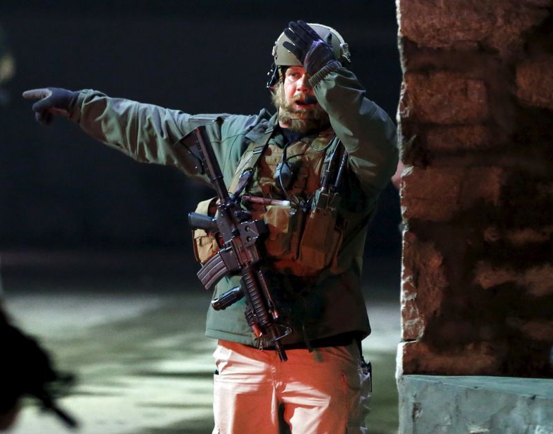 © Reuters. A foreign security personnel stands guard at the site of an explosion in Kabul, Afghanistan